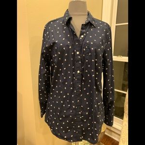 Long sleeve navy blouse with cream color abstract bee design.